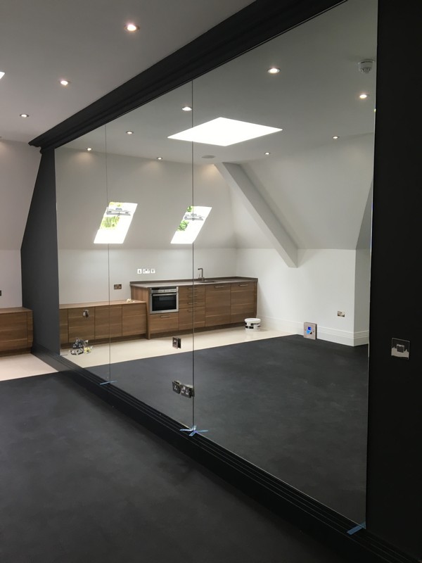 Frameless glass partition in loft conversion by Seven Sisters glaziers
