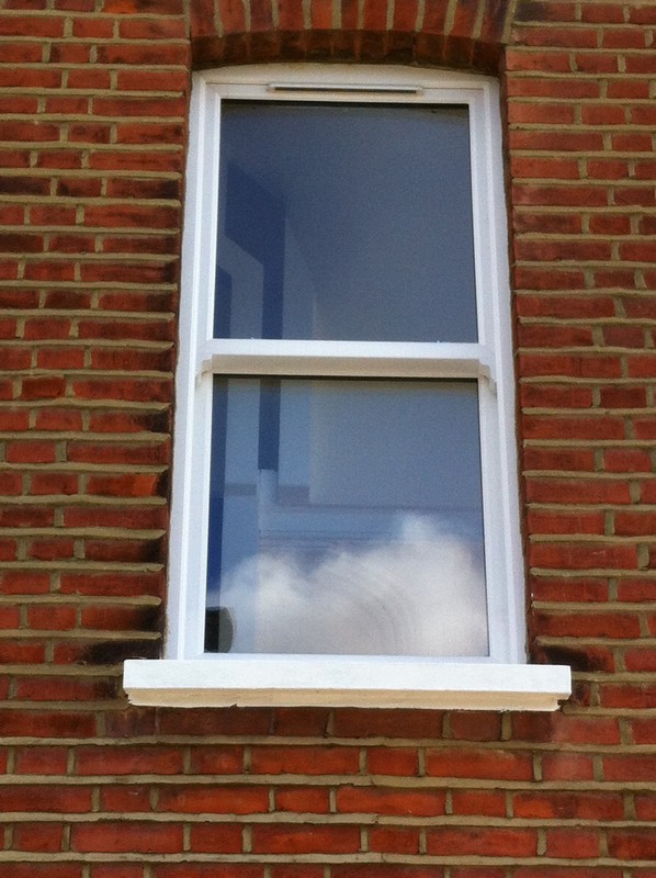 uPVC sash window on Victorian red brick house in Seven Sisters